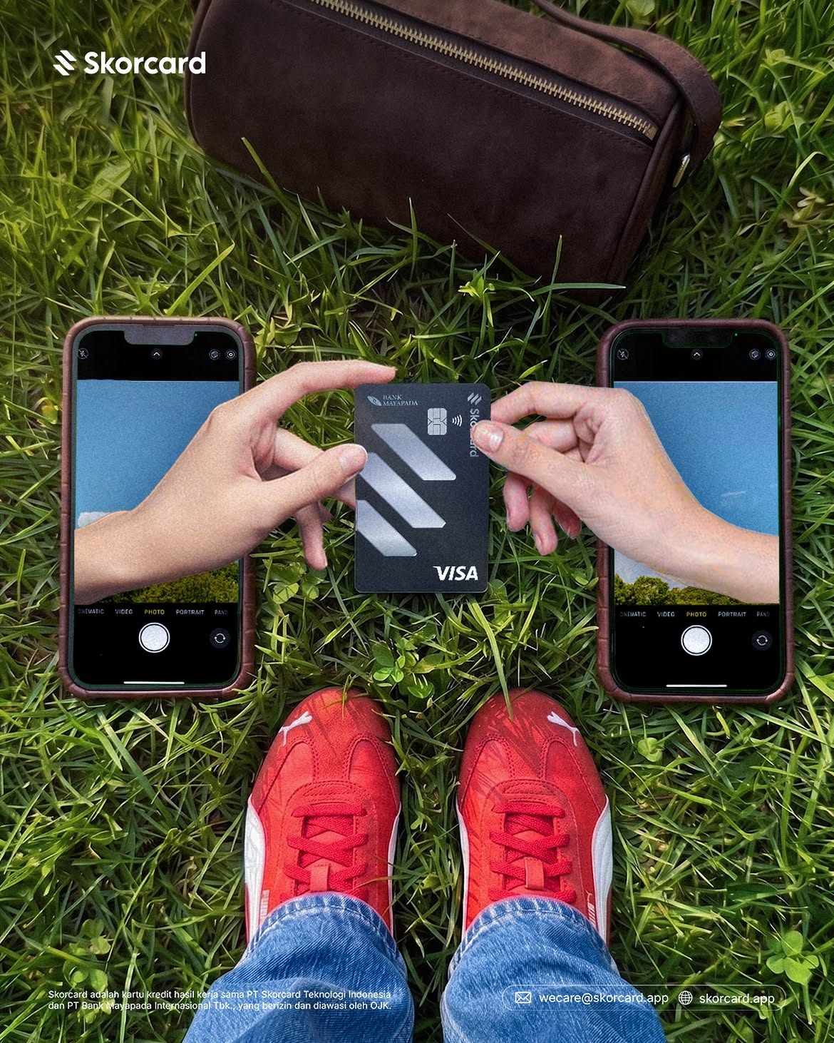Skorcard card held outdoors between two phones